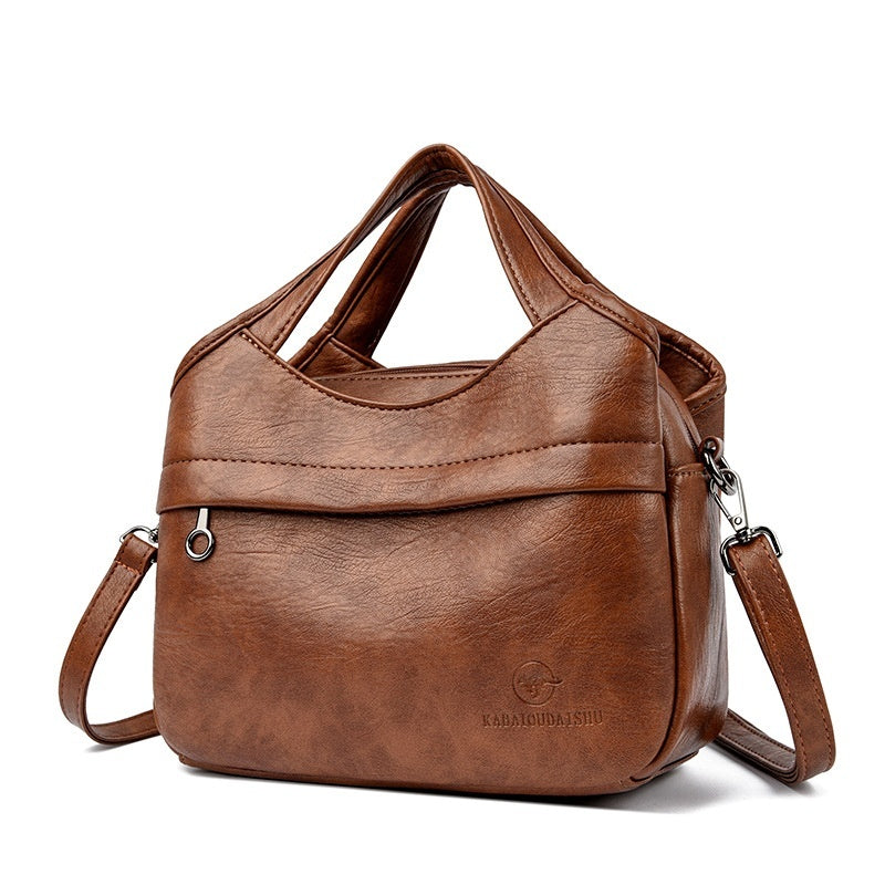 👜Retro dámská kabelka přes rameno, velká kapacita, jednoduchá a všestranná, jednobarevná, volná cestovní taška, vyrobená z vysoce kvalitní měkké kůže.