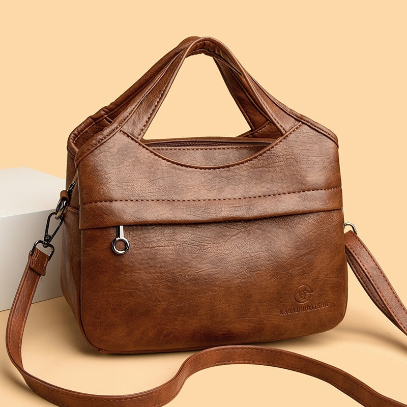 👜Retro dámská kabelka přes rameno, velká kapacita, jednoduchá a všestranná, jednobarevná, volná cestovní taška, vyrobená z vysoce kvalitní měkké kůže.